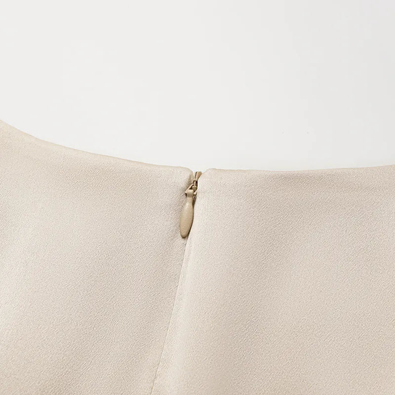 “Date night elegance.” 100% silk pleated top — light matte gold