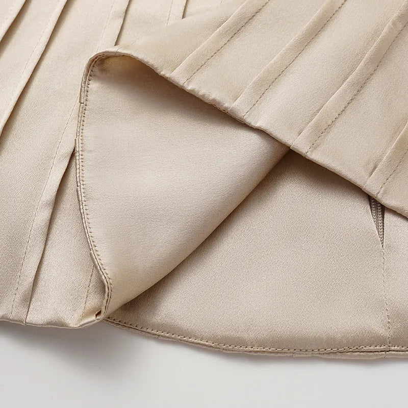 “Date night elegance.” 100% silk pleated top — light matte gold