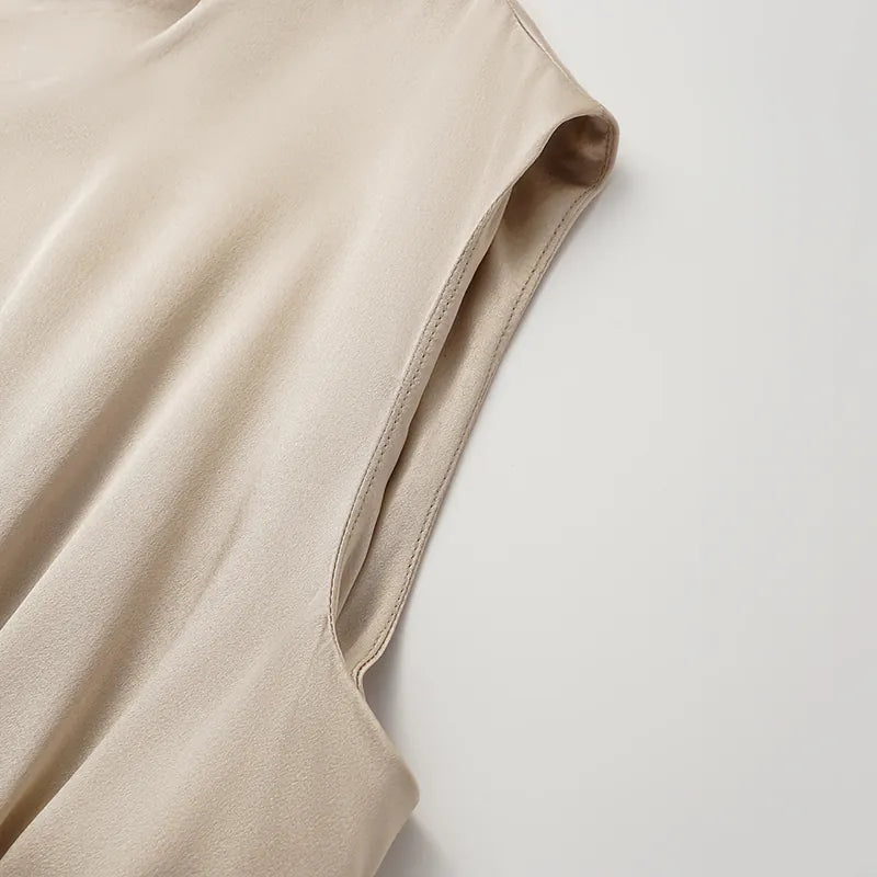 “Date night elegance.” 100% silk pleated top — light matte gold