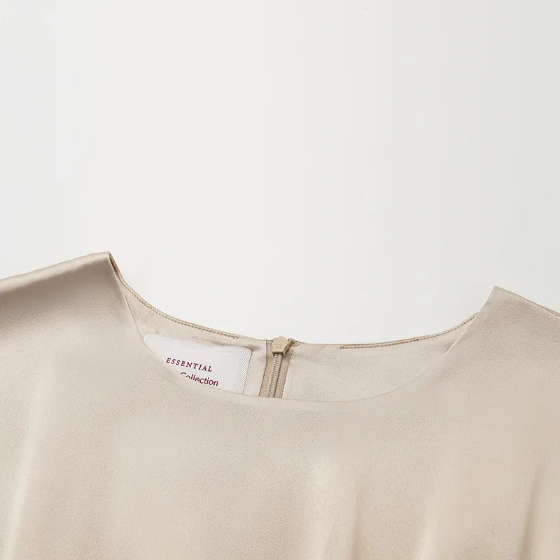 “Date night elegance.” 100% silk pleated top — light matte gold