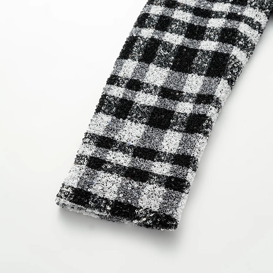 “Welcome to my party.” Sequined shoulder-padded short coat—Classic Checked.
