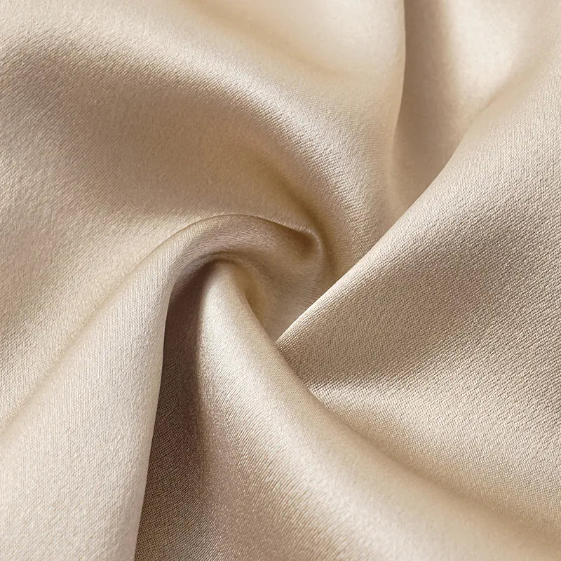“Date night elegance.” 100% silk pleated top — light matte gold
