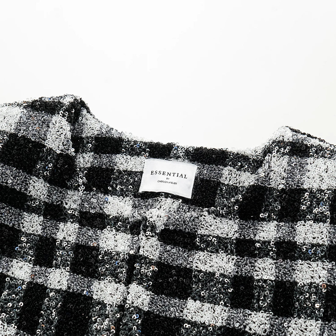 “Welcome to my party.” Sequined shoulder-padded short coat—Classic Checked.