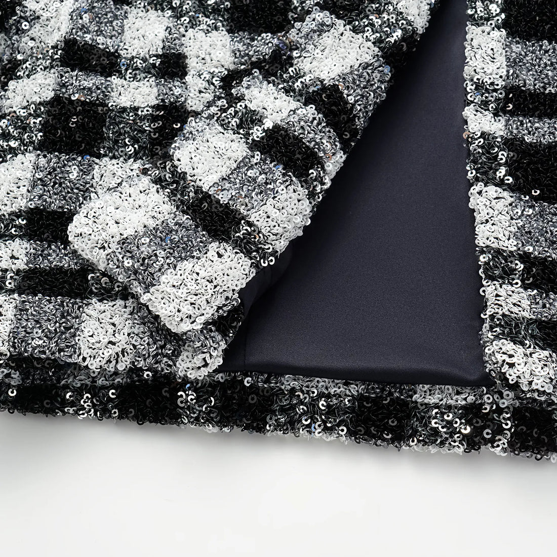 “Welcome to my party.” Sequined shoulder-padded short coat—Classic Checked.
