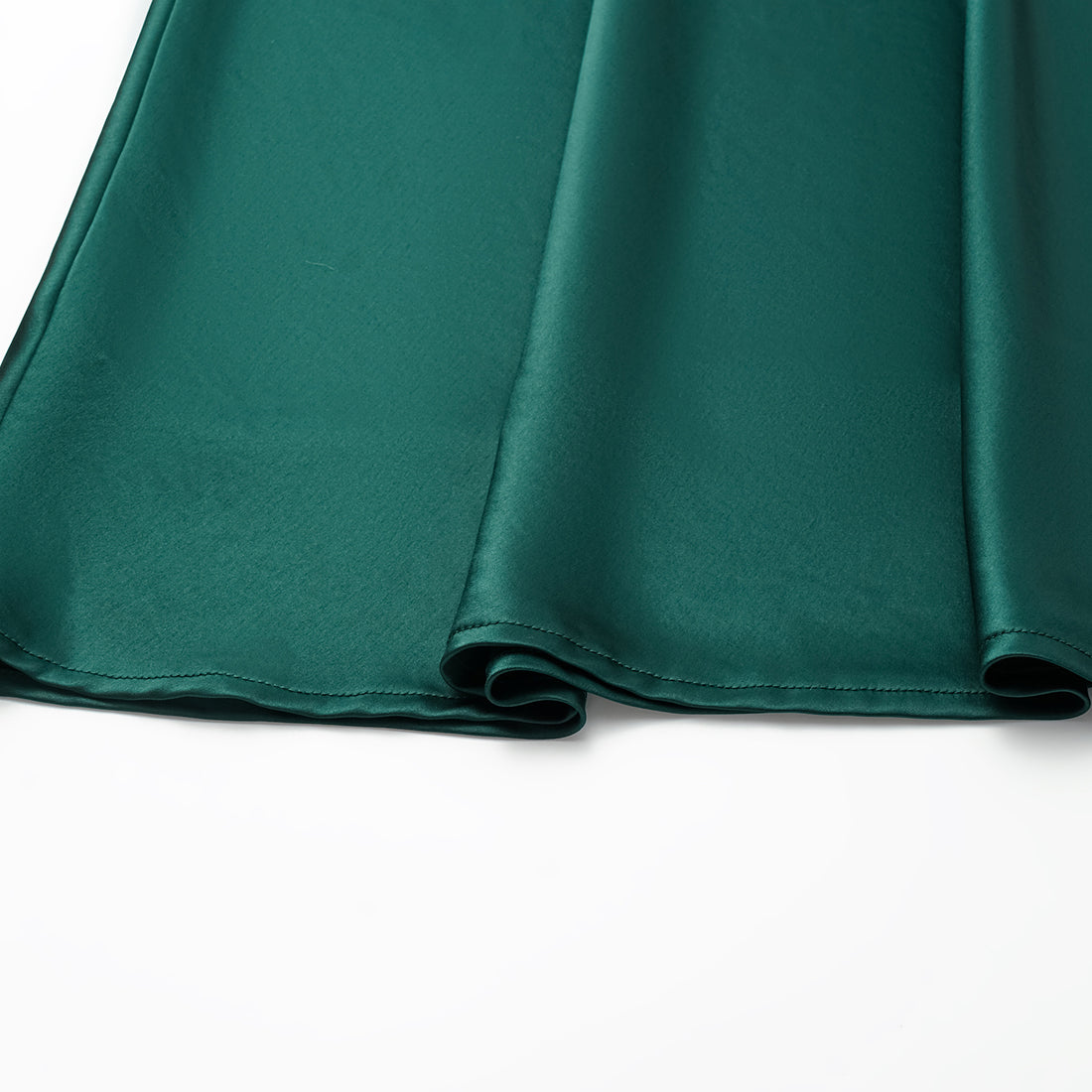 “Daytime sparkle.” Satin draped below-the-knee skirt—Emerald
