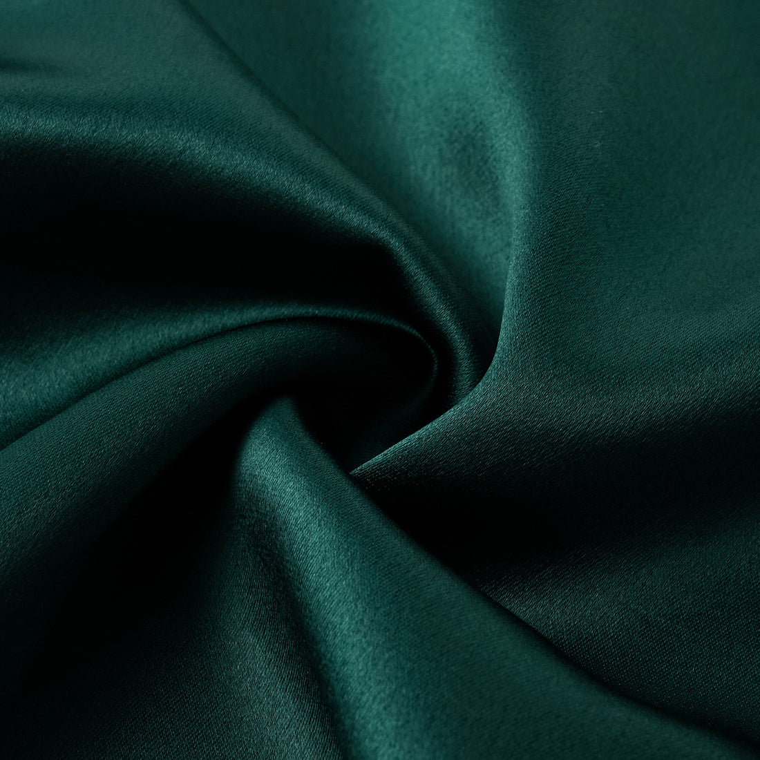 “Daytime sparkle.” Satin draped below-the-knee skirt—Emerald