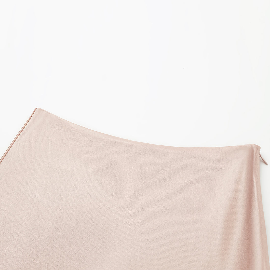 “Daytime sparkle.” Satin draped below-the-knee skirt—nude pink