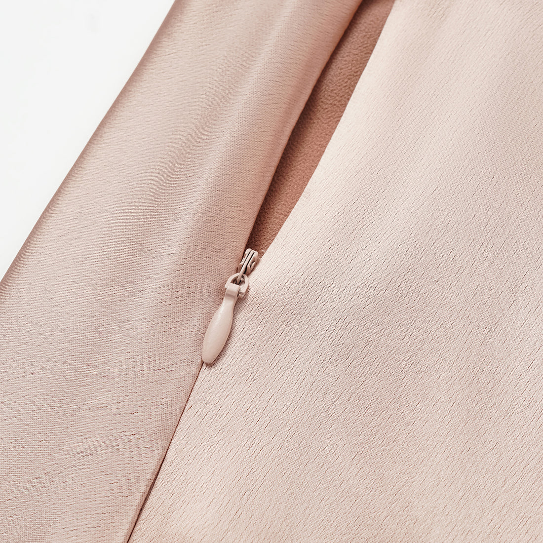 “Daytime sparkle.” Satin draped below-the-knee skirt—nude pink