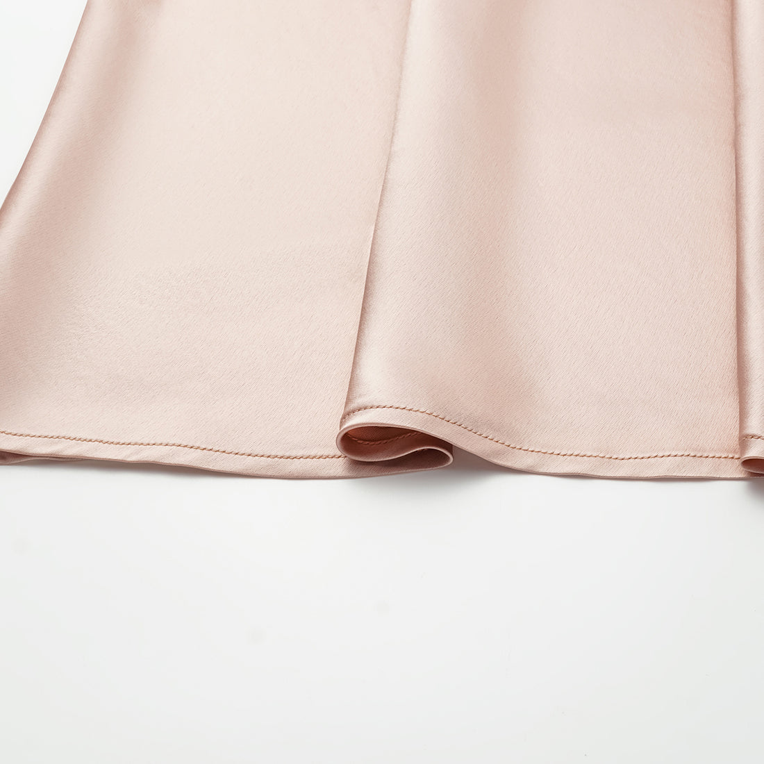 “Daytime sparkle.” Satin draped below-the-knee skirt—nude pink