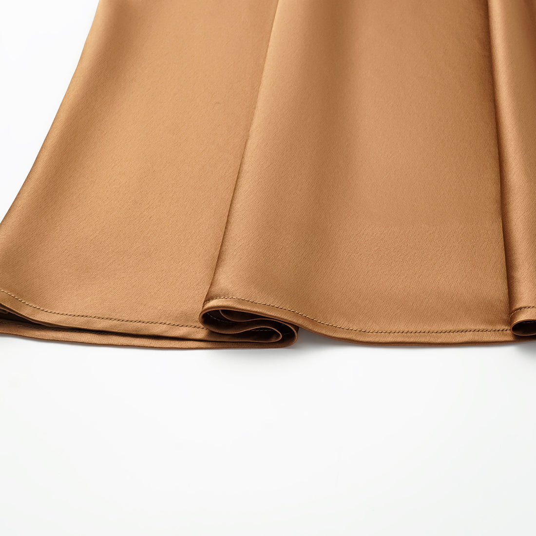 “Daytime sparkle.” Satin draped below-the-knee skirt—Caramel gold