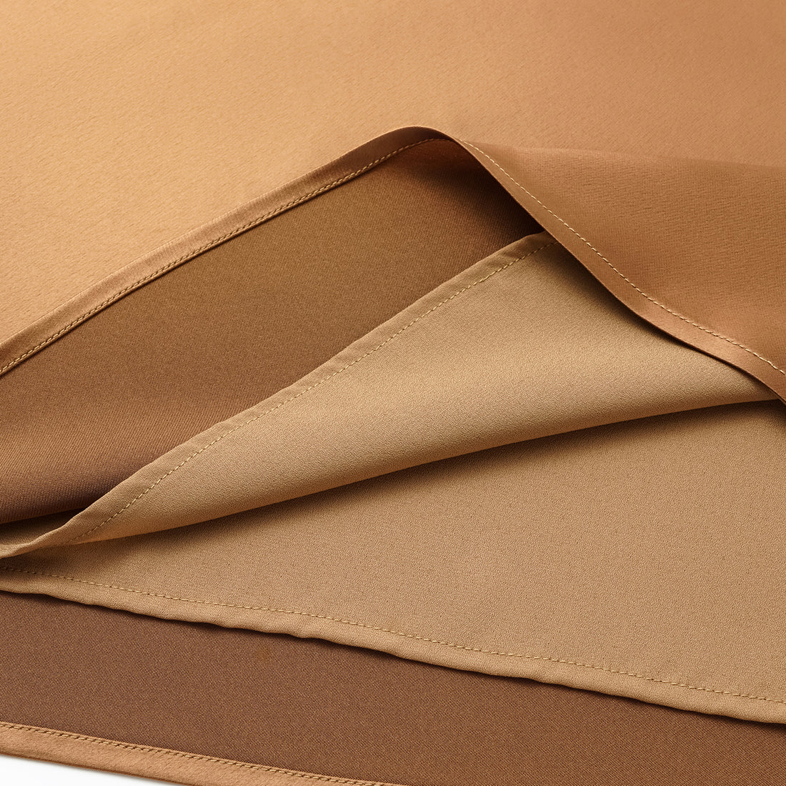“Daytime sparkle.” Satin draped below-the-knee skirt—Caramel gold